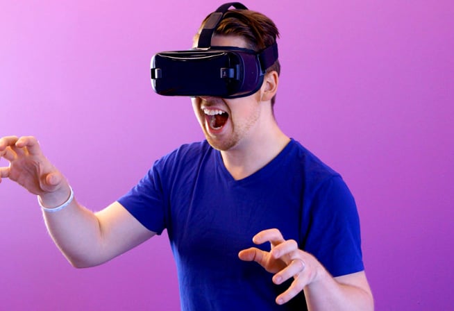 Man wearing VR headset while pretending to be a monster